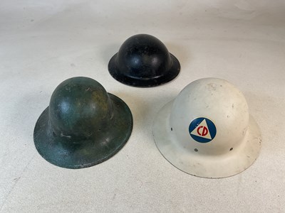 Lot 114 - Three British steel helmets, comprising an ARP...