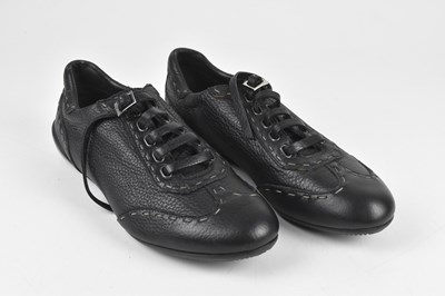 Lot 323 - FENDI; a pair of black pebbled leather trainer...