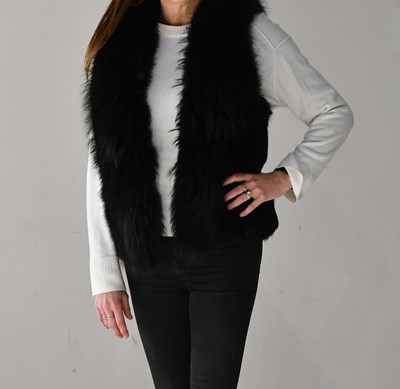 Lot 277 - SUNRISE; a black rabbit fur gilet, trimmed...