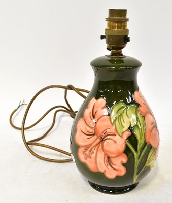 Lot 96 - MOORCROFT; a 'Hibiscus' pattern lamp of...