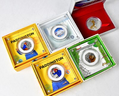 Lot 1125 - ROYAL MINT; four silver-proof 50p coins,...