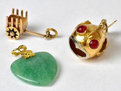 Lot 1276 - Three yellow metal charms, comprising an...