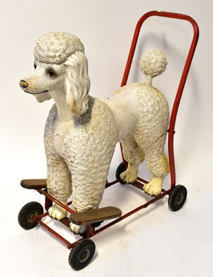 Lot 644 - TRI-ANG; a metal push-along poodle on wheeled...