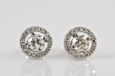 Lot 1360 - A pair of 18ct white gold diamond halo ear...