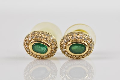 Lot 1409 - A pair of yellow metal diamond and emerald set...