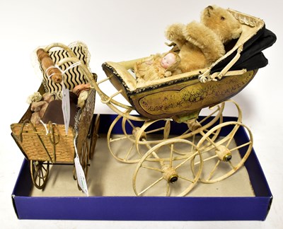 Lot 637 - Two miniature vintage dolls' prams, one...