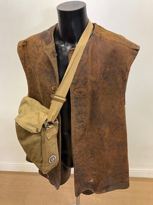 Lot 125 - A WWII British leather jerkin and gas mask.