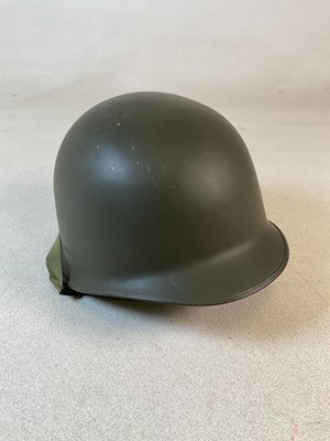 Lot 112 - An American GI helmet, with liner and chin straps