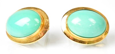 Lot 1312 - A pair of yellow metal earrings, each set with...