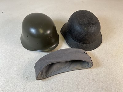 Lot 102 - Three German headwear items, comprising an M35...
