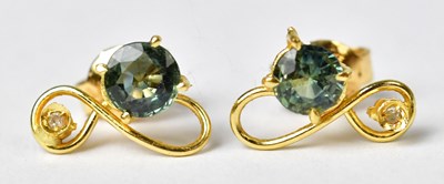 Lot 1314 - A pair of yellow metal stud earrings, each set...