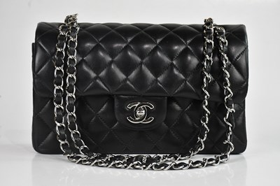 Lot 148 - CHANEL; a black lambskin leather mini Classic...