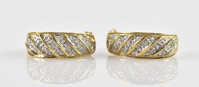 Lot 1410 - A pair of 9ct gold diamond set half hoop...