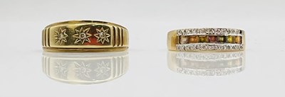 Lot 691 - A 9ct yellow gold and small diamond three...