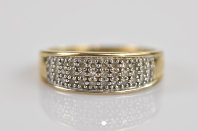 Lot 2589 - A 9ct yellow gold diamond set dress ring with...