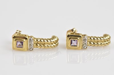 Lot 1411 - A pair of 9ct yellow gold earrings, set with...