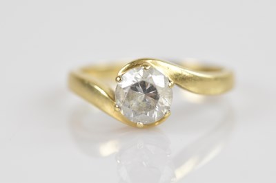 Lot 2490 - An 18ct yellow gold crossover dress ring, set...