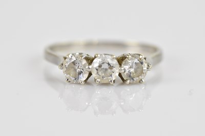 Lot 2371 - A 9ct white gold three stone dress ring, set...