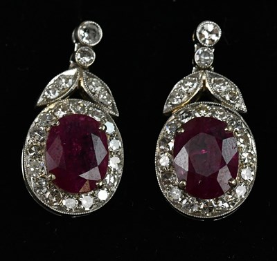 Lot 1369 - A pair of white metal diamond and ruby set...