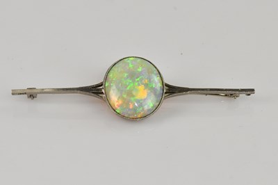 Lot 1275 - A white metal bar brooch, stamped '18ct', set...