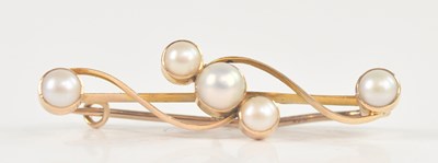 Lot 1304 - A yellow metal pearl set bar brooch stamped...