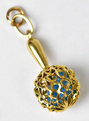 Lot 1244 - A gold charm in the form of a rattle set with...