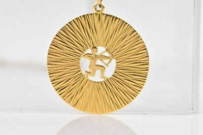Lot 2017 - A yellow metal disc pendant, with textured...