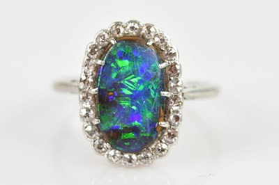Lot 2493 - A white metal diamond set fire opal dress ring,...