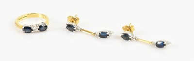 Lot 2298 - An 18ct yellow gold diamond and sapphire three...