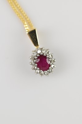 Lot 624 - A yellow and white metal diamond set pendant,...