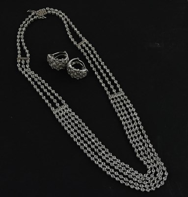 Lot 2001 - A white metal four-strand diamond set necklace,...