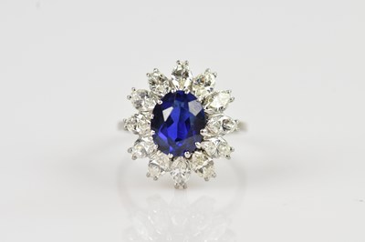Lot 2243 - A white metal diamond and sapphire cluster...