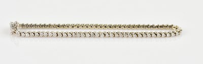 Lot 1107 - A white metal diamond set tennis bracelet, set...