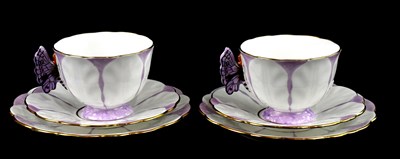 Lot 75 - AYNSLEY; a pair of Art Deco trios, the handles...