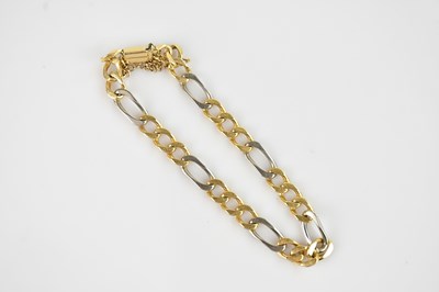 Lot 1111 - A yellow metal curb link bracelet, with...