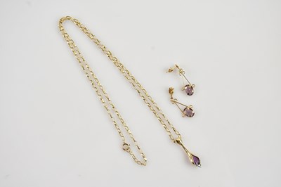 Lot 613 - A yellow metal amethyst drop pendant on a 9ct...