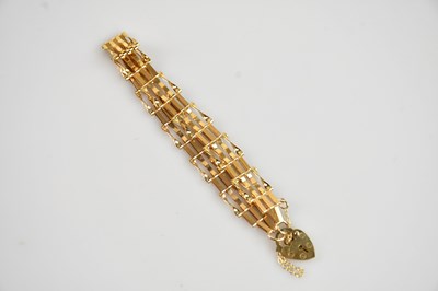 Lot 592 - A 9ct gold gate link bracelet, with padlock...
