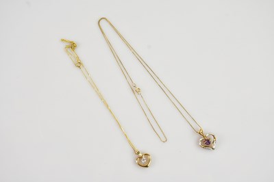 Lot 614 - Two yellow metal gem set heart shaped pendants...
