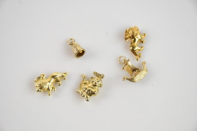 Lot 683 - Five yellow metal charms, two modelled as...