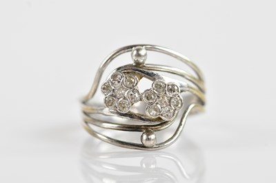 Lot 673 - A silver and diamond set double flower head...