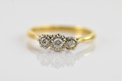 Lot 640 - An 18ct gold three stone diamond ring,...