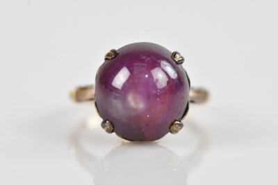 Lot 2439 - A yellow metal star ruby cabochon dress ring,...
