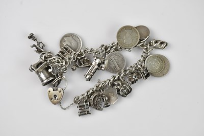 Lot 1247 - A silver charm bracelet set with a large...