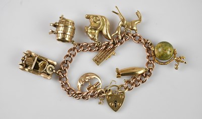 Lot 1098 - A 9ct gold charm bracelet set with various...