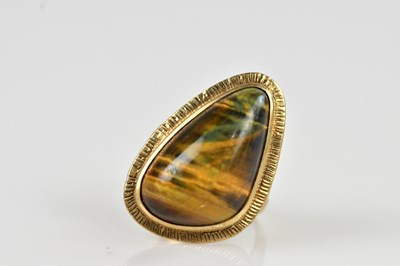 Lot 2444 - A 9ct yellow gold tiger eye ring, size O,...