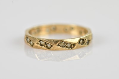 Lot 2579 - A 9ct yellow gold eternity ring set with small...