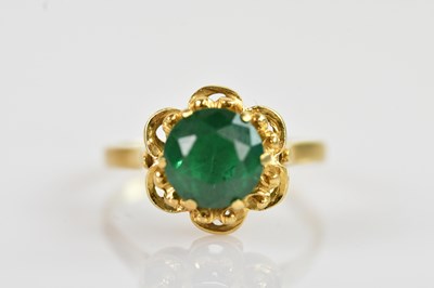 Lot 2351 - A yellow metal emerald set dress ring, the...
