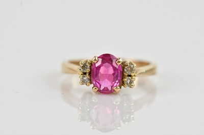 Lot 2352 - A yellow metal dress ring, set with a pink...