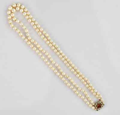 Lot 2155 - A two-strand pearl necklace, set with a 9ct...