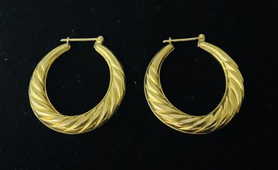 Lot 747 - A pair of 9ct yellow gold creole hoop earrings,...